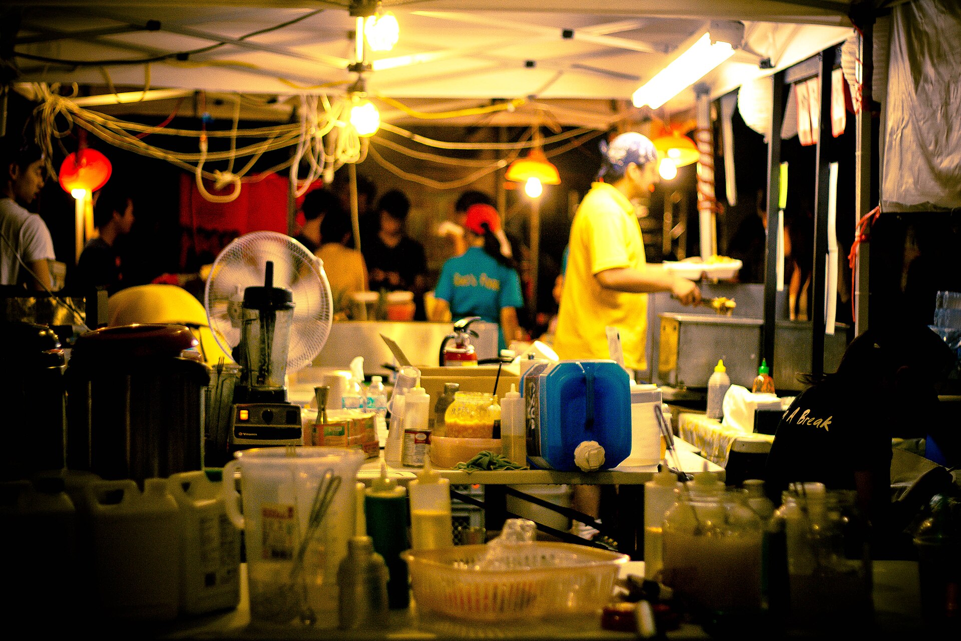 Evening night market with lit food booths
