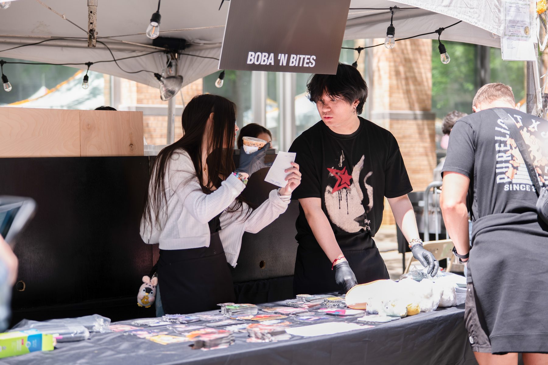Boba &rsquo;N Bites staff taking an order at the tent